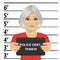 Arrested senior woman posing for mugshot holding a signboard