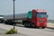 Arrival of two heavy trucks transporting masts for the construction of the wind turbine in the city of the sun