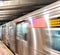 Arriving subway train in New York City station with people waiting