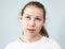 Arrogant facial expression, pre-teen Caucasian girl rolled her eyes, background, emotions series
