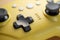 Arrow buttons of a yellow game controller close-up