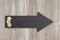 Arrow chalkboard sign with gold coins on weathered wood