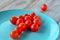 Arrow shape of Cherry tomatoes on a turquoise plate