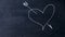 Arrow struck heart. Handwritten chalk on a black chalkboard. Cupid arrow shoots heart