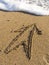 Arrow on wet sea sand