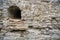 Arrowslit and limestone castle wall