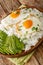 Arroz con huevo or rice with fried egg is the ultimate Latin lazy lunch close up in the plate. Vertical