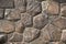 Art background of large brown stone boulders in an ancient wall with high-precision masonry face to face for the original