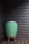 Art big water green jar hand made ceramic on wall wooden background