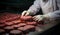 The art of butchery unfolds as skilled hands process flavorful hamburger patties