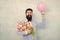 Art of charm. Happy hipster go out on date. Bearded man hold tulips and balloon. Perfect first date flowers. Floral gift