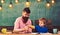 Art class in kindergarten. Teacher and kid drawing a picture. Father holding stack of colorful pencils