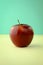 Art composition, design food - bright red apple isolated on bicolored green and yellow background, trendy pastel colors