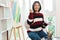 The art concept, Asian female artist in sweater smiling to happy after painting artwork success