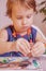 Art, creativity, beauty childhood concept. Little cute child girl painting with colorful hands