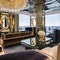 Art Deco Lounge: An opulent art deco lounge with geometric patterns, mirrored surfaces, and a luxurious velvet sectional sofa fo