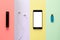 Art design concept gadgets. smartphone, power Bank, headphones, flash drive on a multi-colored striped background