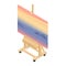 Art drawing class concept. Paint desk easel with sunset and mountains painting.