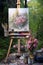 art easel, paintbrushes and canvas outdoors