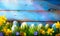 art Easter Background with easter eggs and spring flowers on green grass