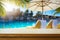 Art Empty wooden table on sunny blurred tropical pool  background. Outdoor party mockup for design and product display