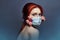 Art fashion redhead woman with medical respirator on her face, rose flowers grow from under mask, clean air lack of oxygen