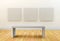 Art gallery with empty seat and white canvases
