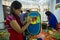 Art institute student painting a big size owl face.