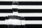 Art mannequin black and white stripes, on striped with black and white stripes. Disguise.