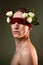 ART portrait of a handsome young man blindfolded and white roses. Male beauty.