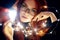 Art portrait of a woman with red hair in Christmas lights. Girl in glasses with reflected Christmas lights. Red hair in a yellow