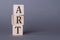 Art word on wooden cube blocks on dark gray background. Art sales concept