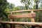 Artesanal Wooden bench bank in middle of trekking path at forest mountains