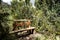 Artesanal Wooden bench bank in middle of trekking path with nature and mountains at background