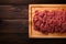 Artful composition top view of uncooked minced beef on wood