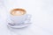 Artful Delight: Cup of Latte with a Heart-Shaped Design on a White Table