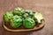 Artichoke flower buds. Fresh raw artichoke on wooden background close up