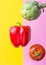 Artichoke ripe juicy tomato red bell pepper floating levitating on duotone yellow pink background. Creative food poster.