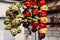 Artichokes and peppers of various colors hanging in a kitchen