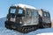 Articulated military tracked cargo vehicle on snow