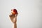 Articulated wood hand holding a red apple