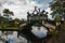 An artificial bridge with four statues of dragons with twisted tails, Tirta Gangga park, Karangasem, Bali, Indonesia