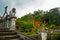 An artificial bridge with four statues of dragons with twisted tails, Tirta Gangga park, Karangasem, Bali, Indonesia