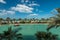 Artificial canal with traditional Arab boat abra, palm and beach