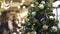 Artificial christmas green tree decorated with white and yellow christmas balls