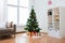 Artificial christmas tree and presents at home