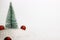 Artificial Christmas tree in rubber or polypropylene granules. Chemical industry. Plastic. New Year`s and Christmas. Red shiny bal