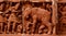 Artificial clay made elephant sculptures on a red wall