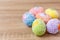 Artificial color eggs on wooden plank background. For Easter day