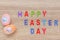 Artificial color eggs on wooden plank background. For Easter day